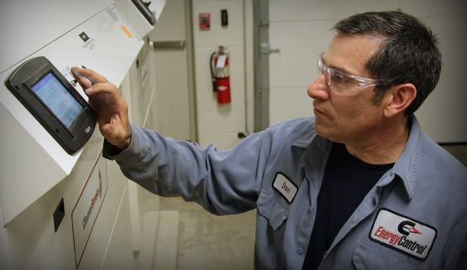Energy Control service technician operating boiler touchscreen controls