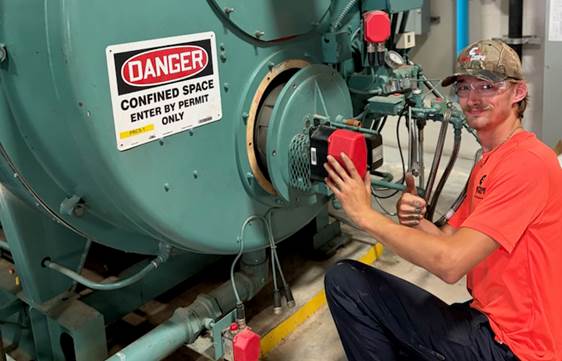 Energy Control team member working on boiler equipment